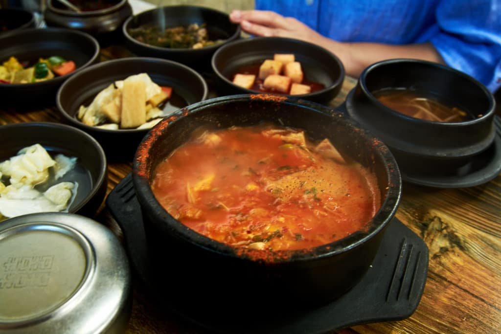 Table with Korean food including soup