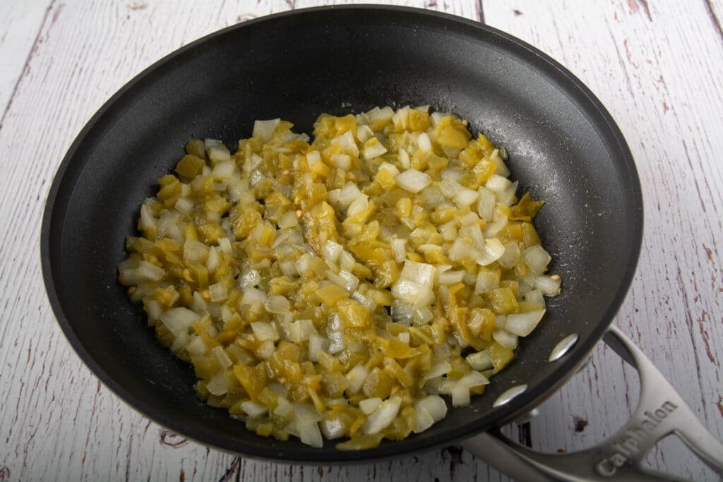 Cooked green chilies and onions in a pan