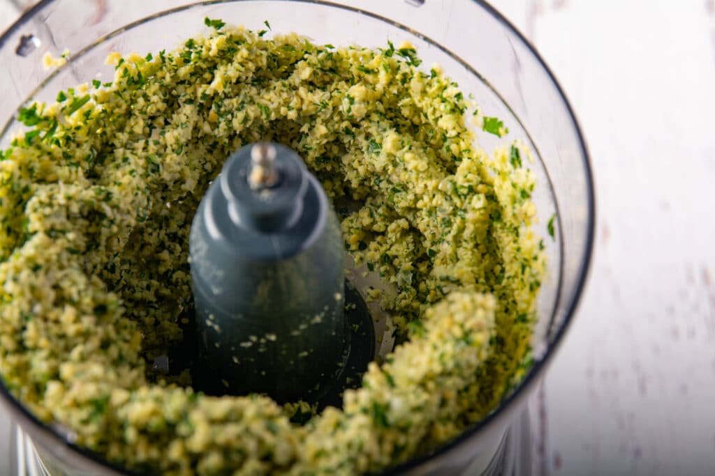 Food processor with partially ground up falafel ingredients
