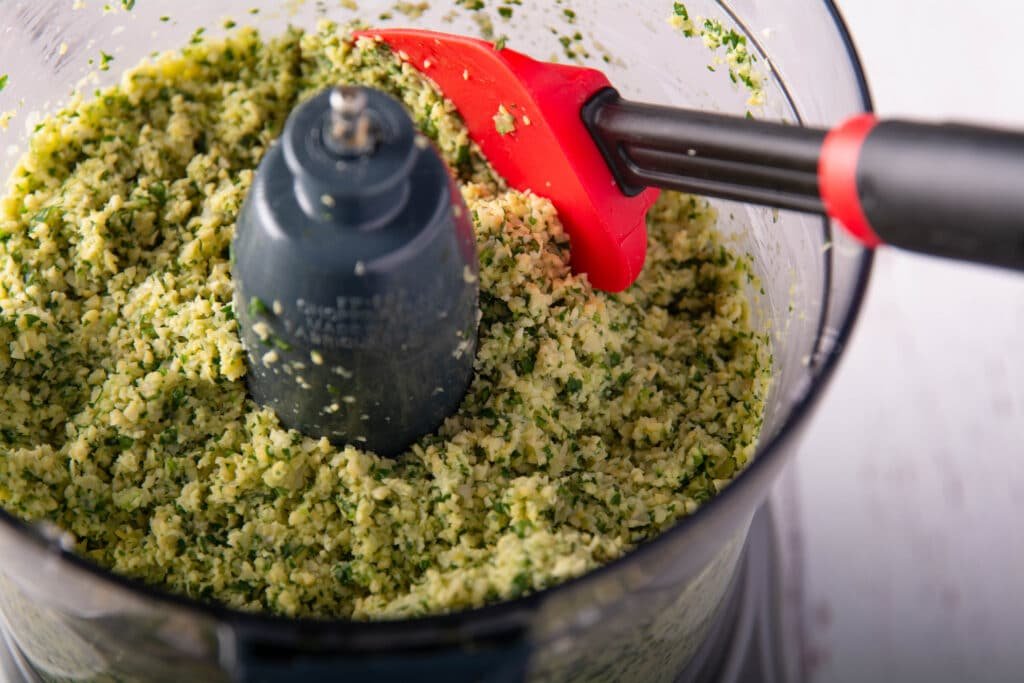 Food processor with ground up falafel ingredients
