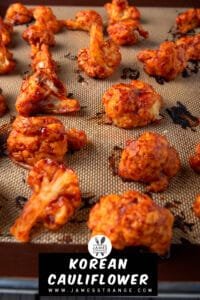 Oven baked cauliflower wings in a spicy Korean sauce on a baking pan fresh out of the oven. This is a pin for Pinterest