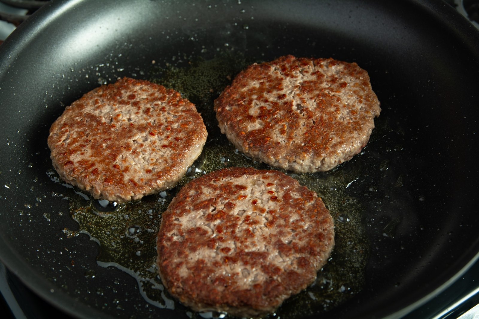 Burger patties in a pan