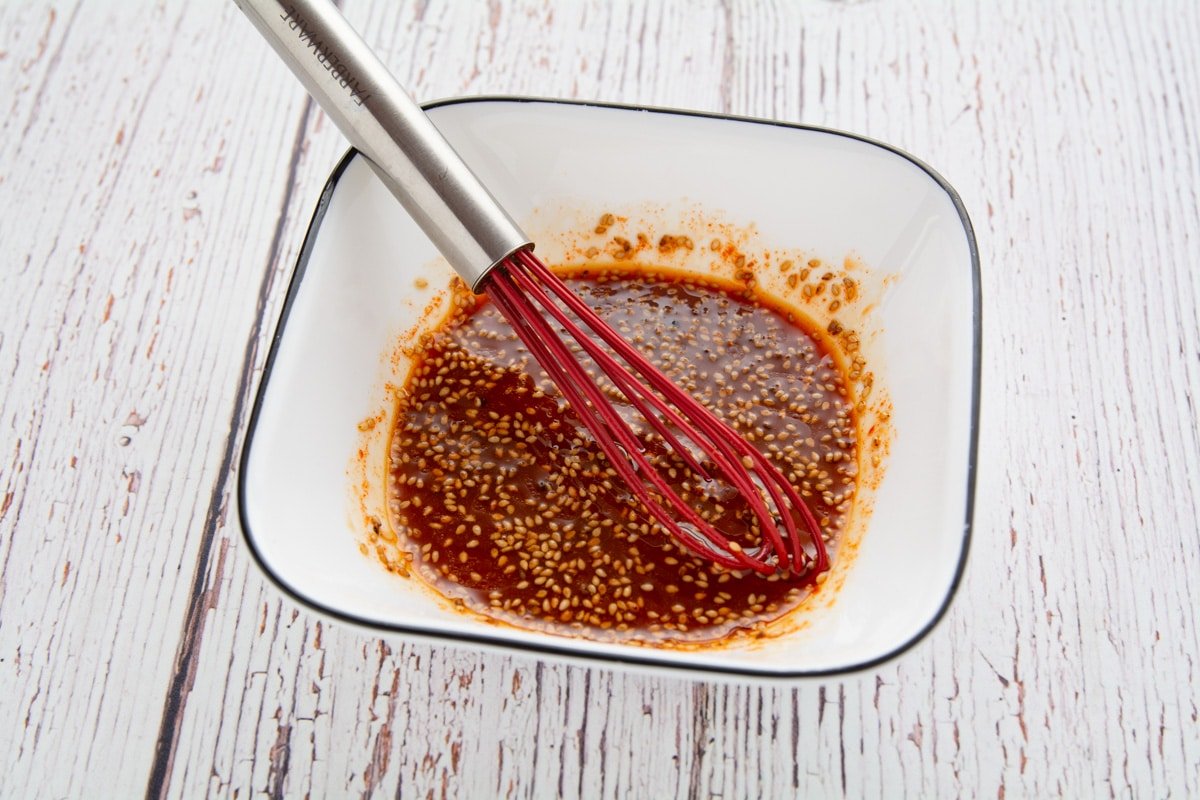 Spicy sauce in a bowl with a whisk