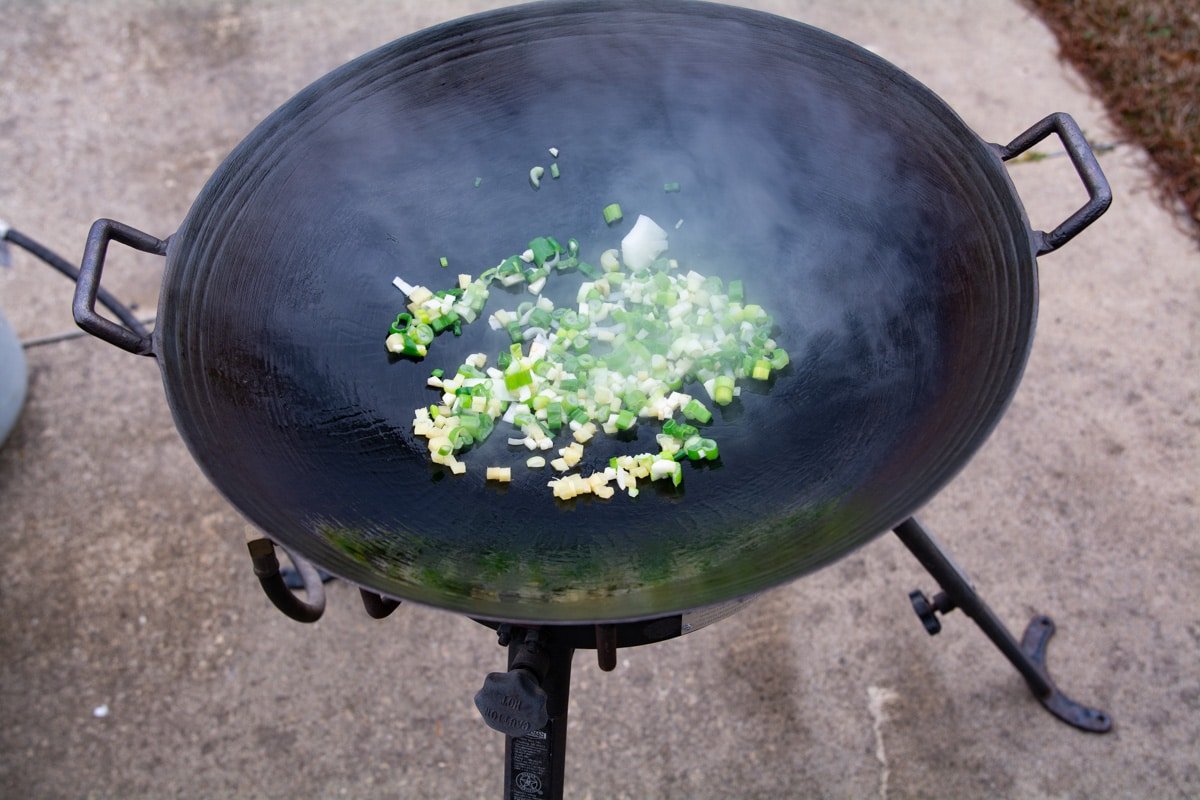 Garlic, ginger, and green onions in a wok.