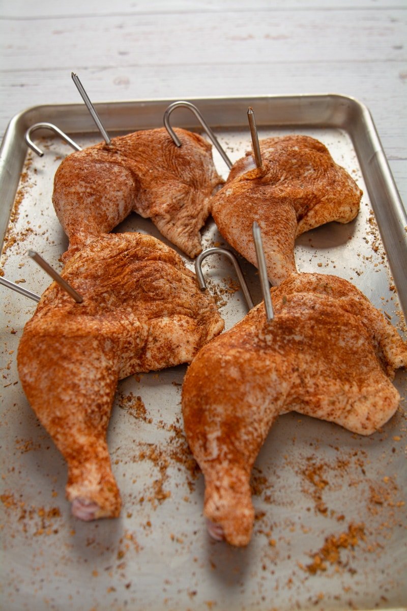 Chicken leg quarters seasoned with dry rub