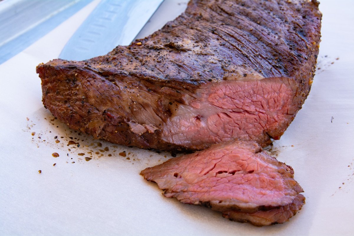 Cooked trip tip that has been sliced. The tri tip is medium rare.