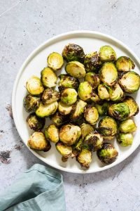 A plate with brussel sprouts cooked in the air fryer. 