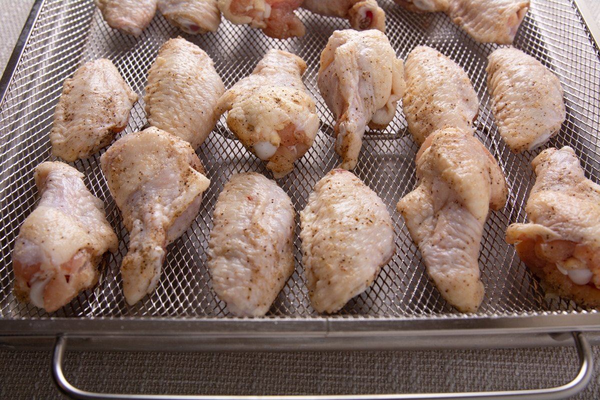 Seasoned wings on an oven tray