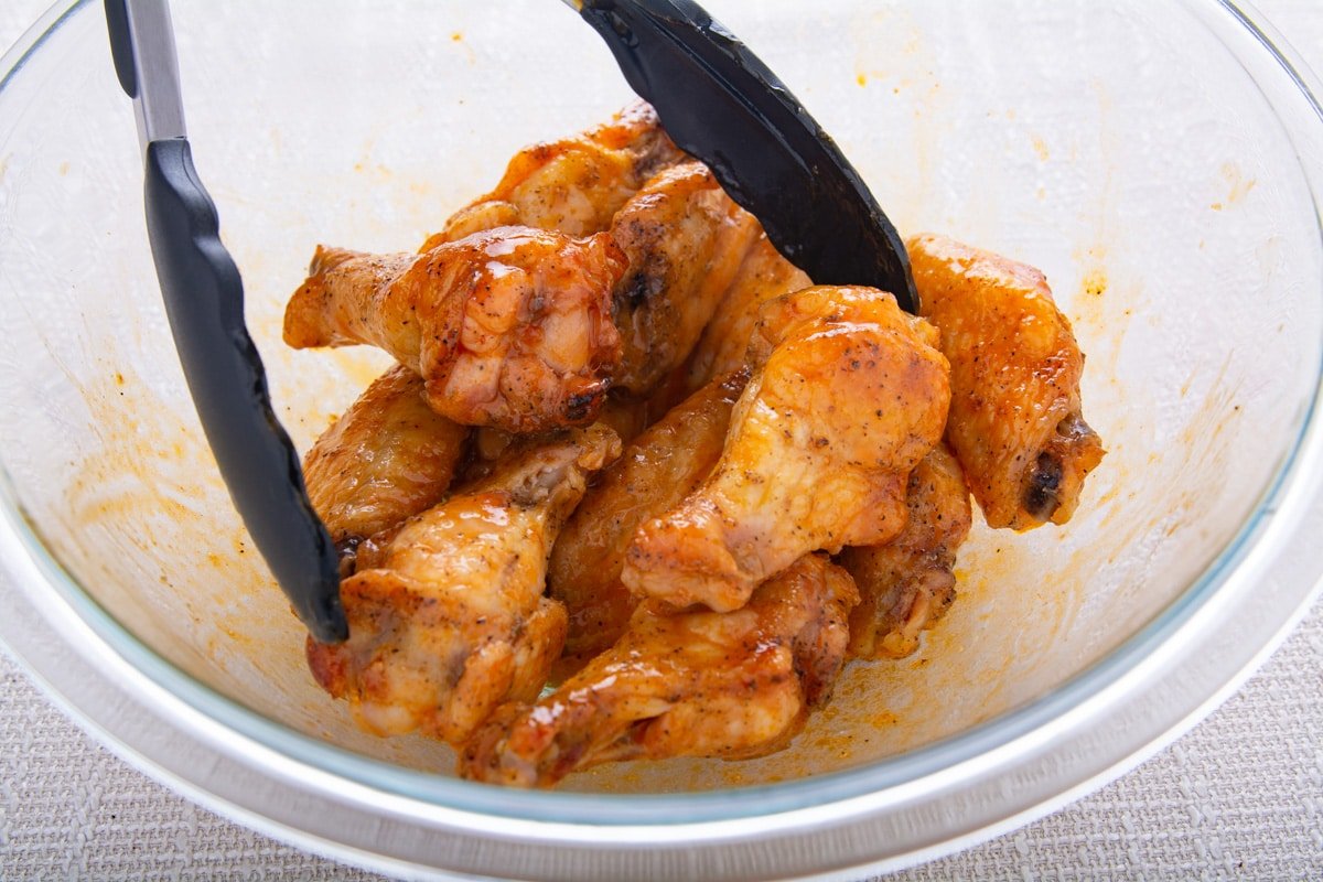 Wings in a bowl with sauce.