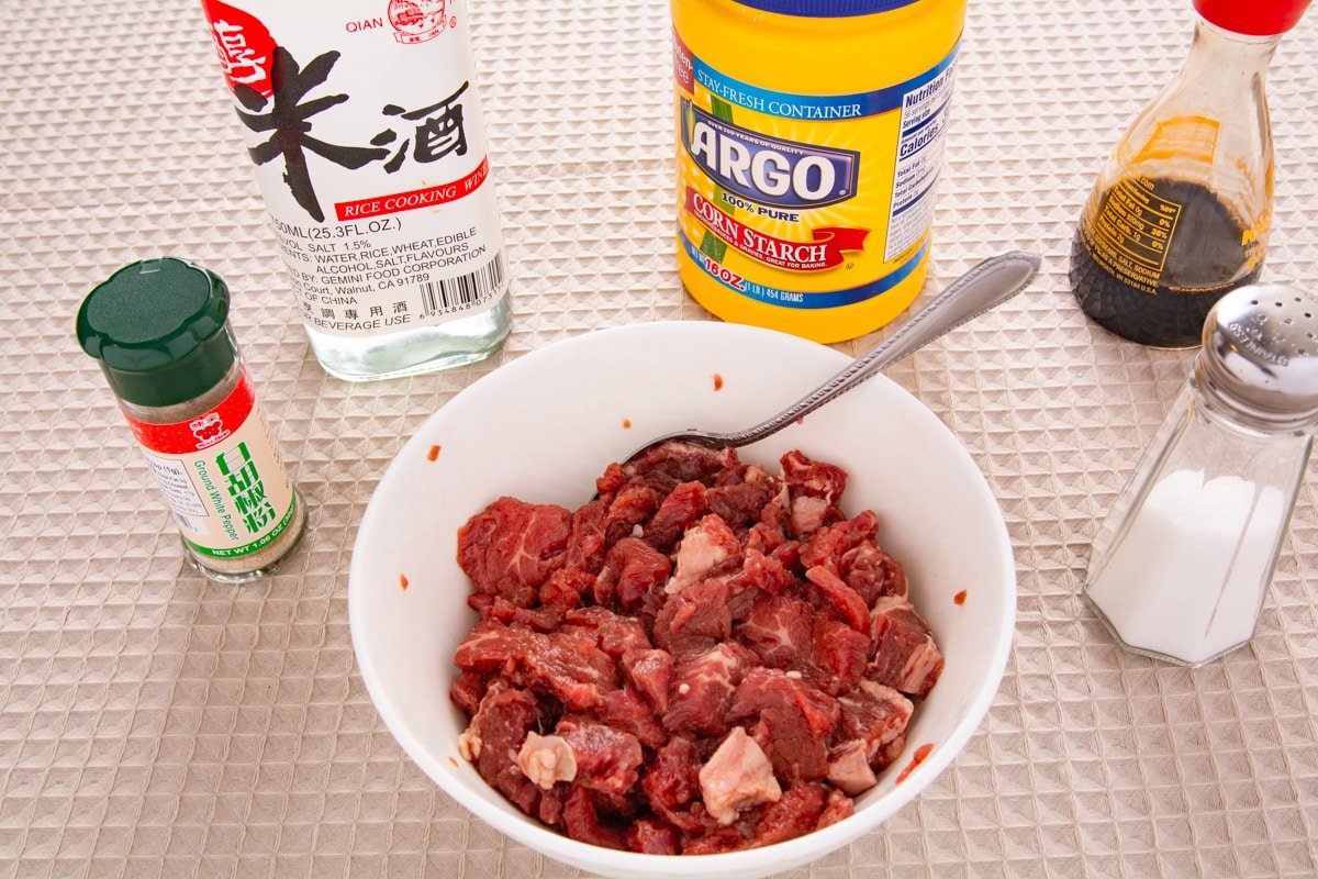 Sliced beef marinating in a bowl.