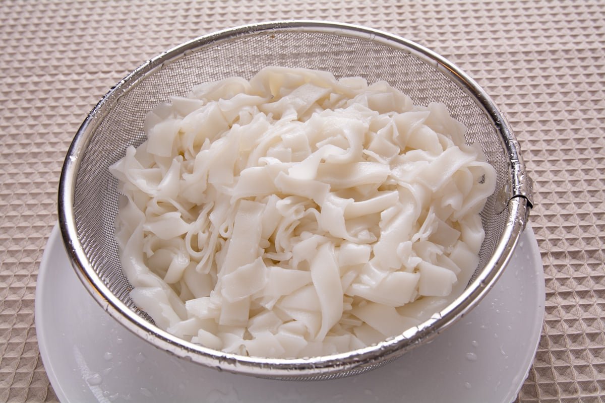 Soft rice noodles in a strainer
