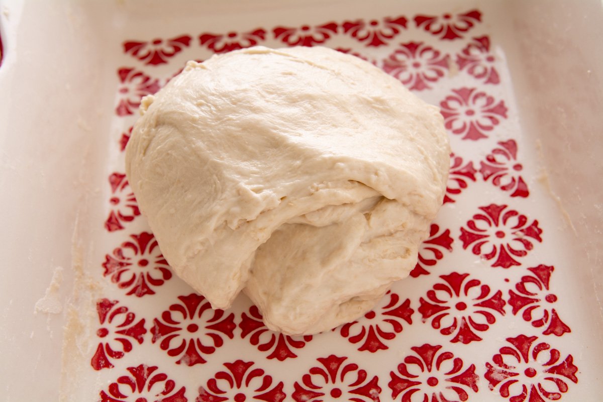 Stretched dough rolled up and in a bowl