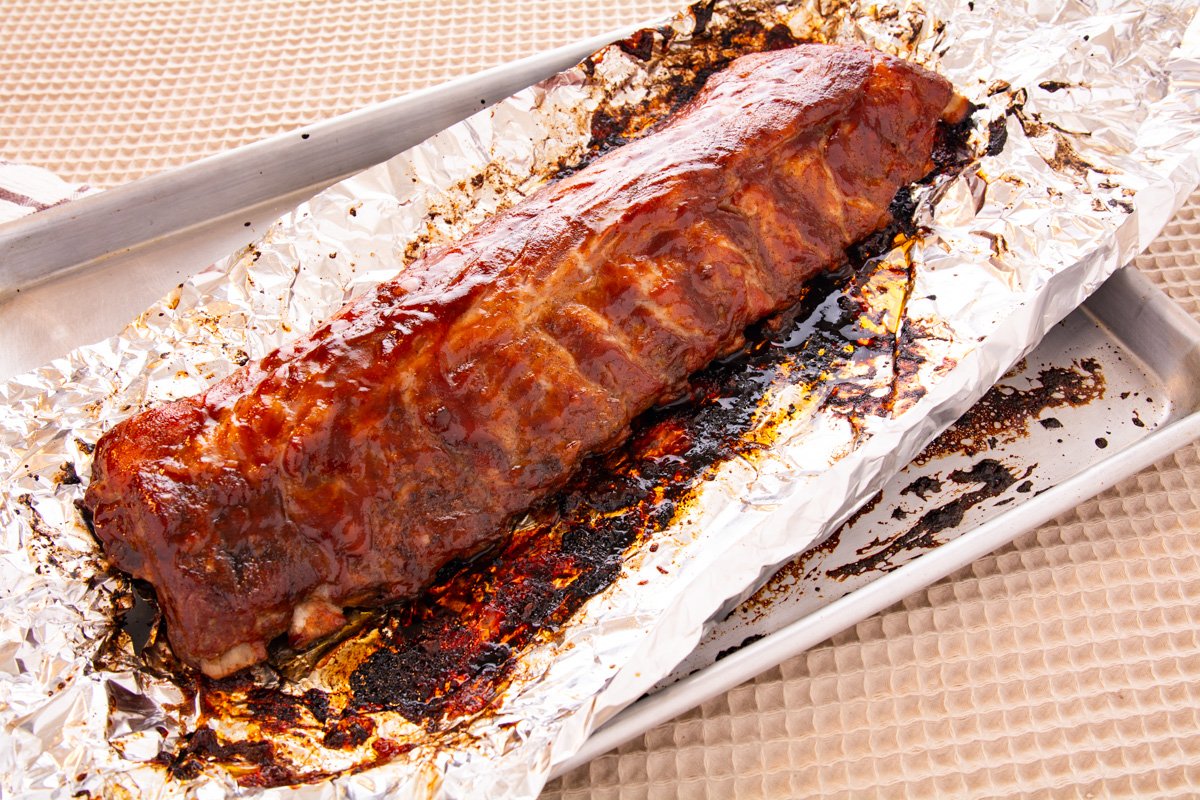 Cooked slab of ribs on a baking tray