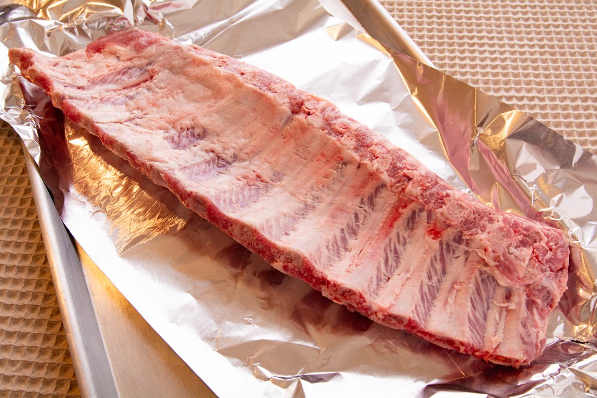 Raw ribs, membrane removed and dried on a tray