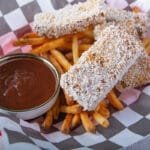 Extra crispy tofu with french fries and bbq sauce in a fast food basket