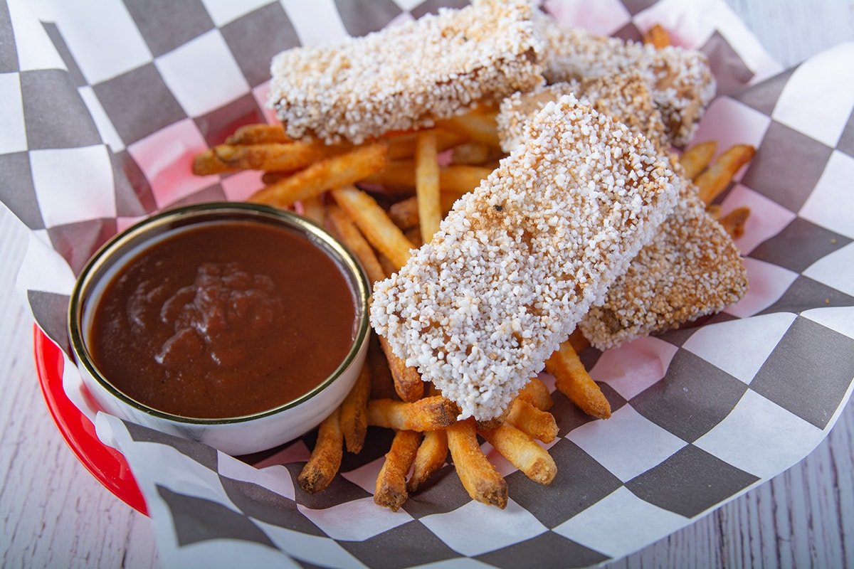 Extra crispy tofu with french fries and bbq sauce in a fast food basket