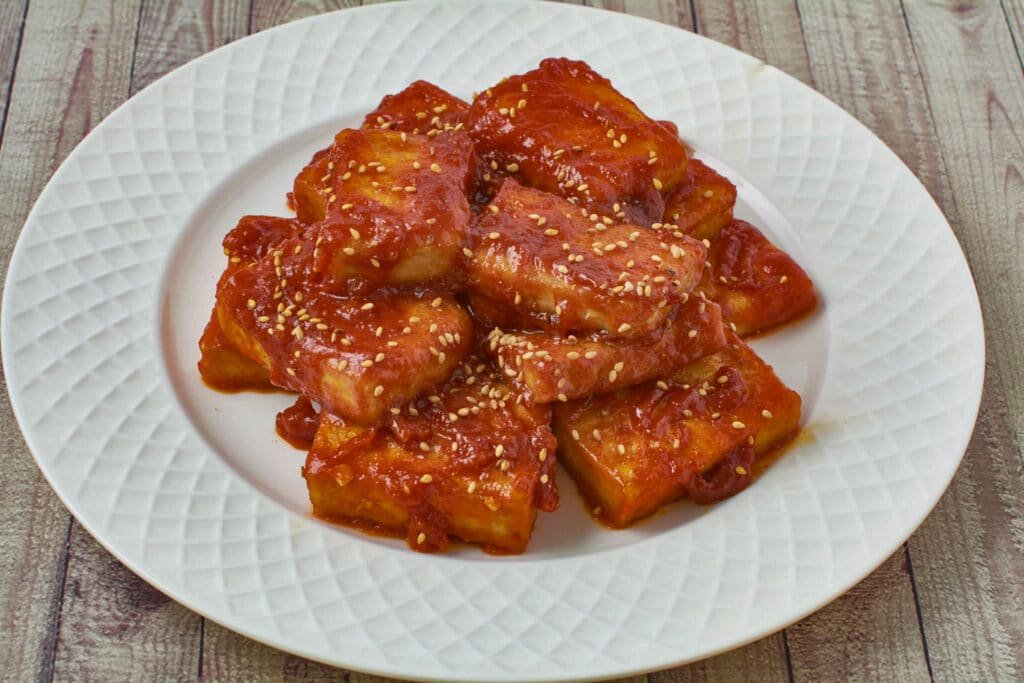 Fried tofu in a spicy sauce on a plate
