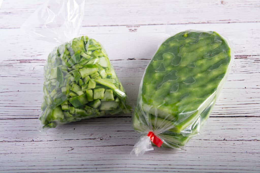 Nopales in bags, one bad is cut up and one one bag only has the thorns removed.