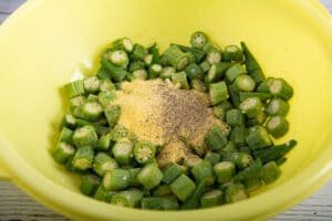 Cut up okra with cornmeal in a bowl