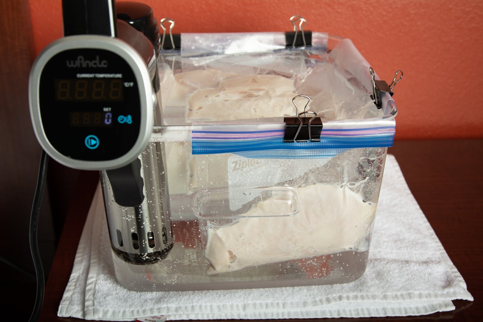 Bags of chicken breast in a tank with a sous vide machine.