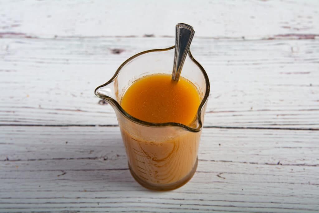 Prepared sauce in a measuring cup with a spoon
