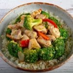 Finished chicken and broccoli in a bowl on a table.