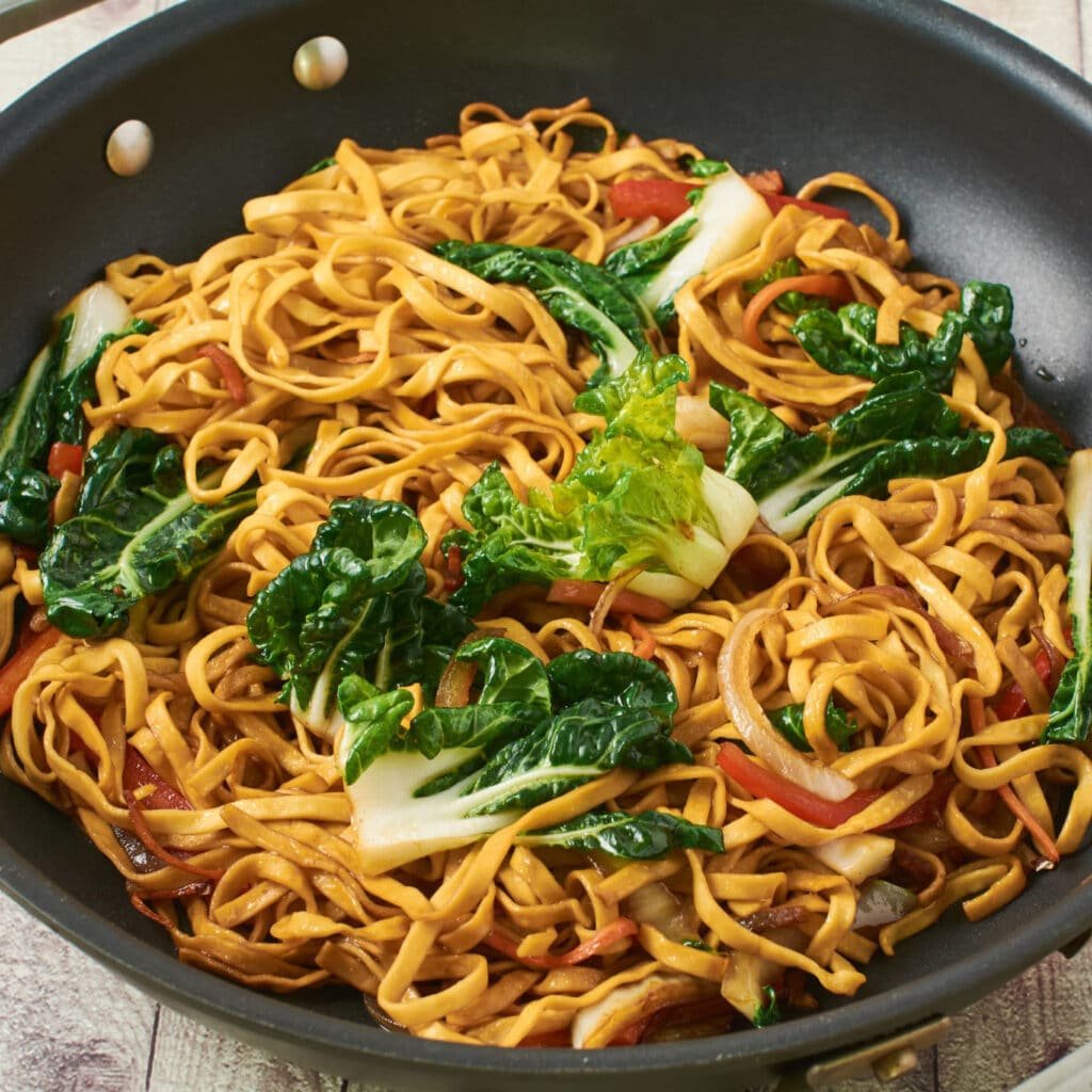 Simple vegetable chow mein in a pan on a table