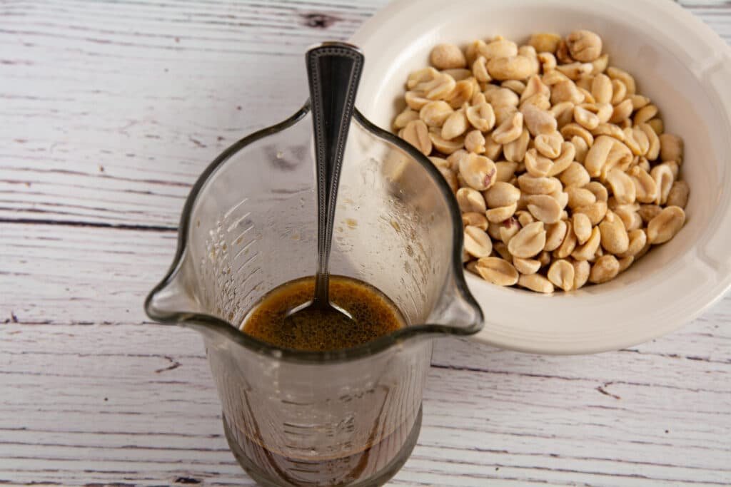 Sauce in a jar and peanuts in a bowl