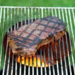 Steak cooking on a grill