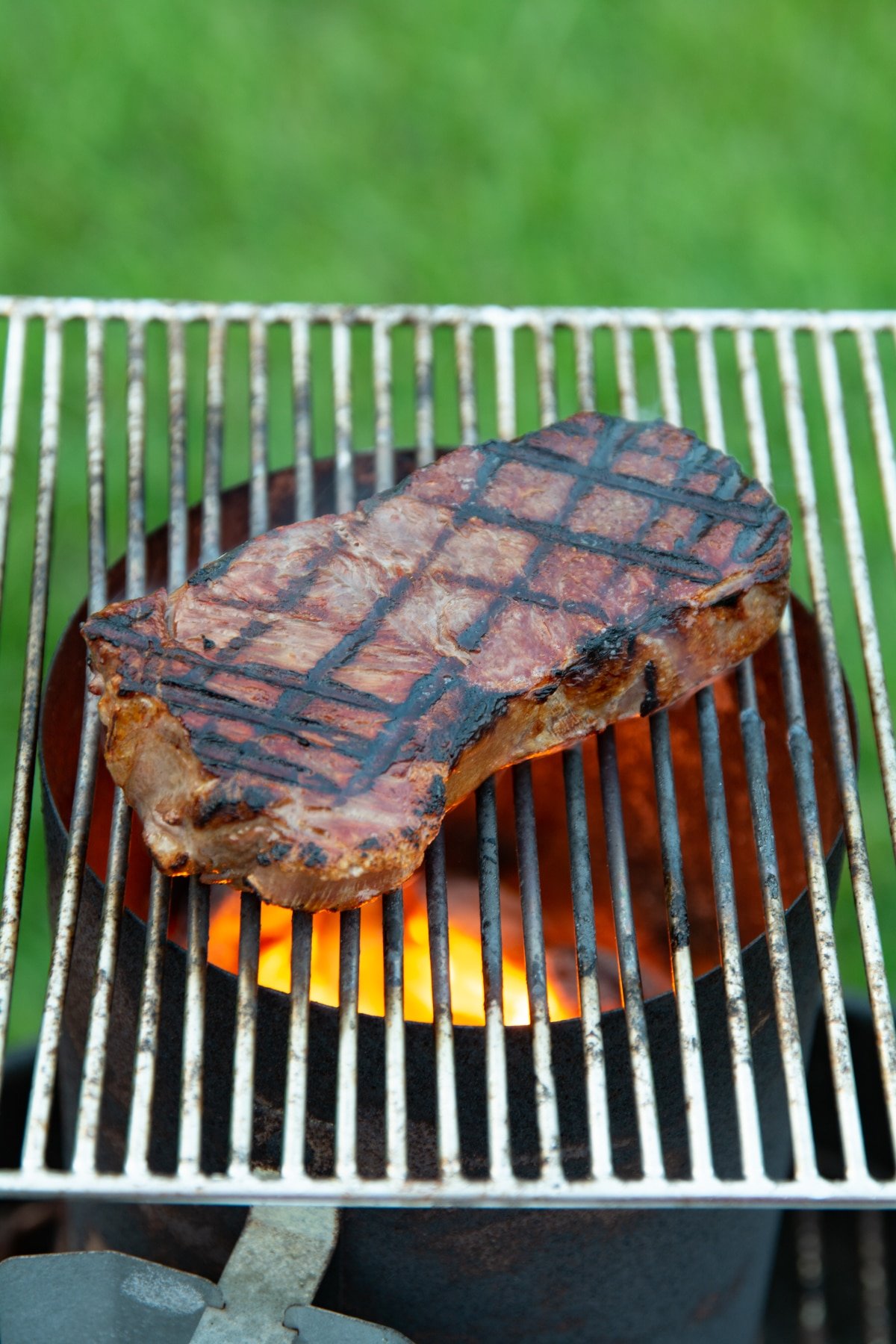 Steak cooking on a grill