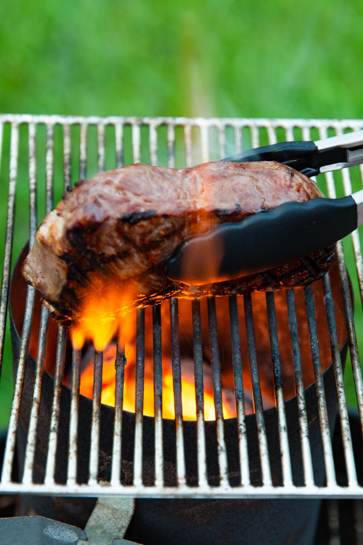 Steak cooking on a grill, cooking the sides
