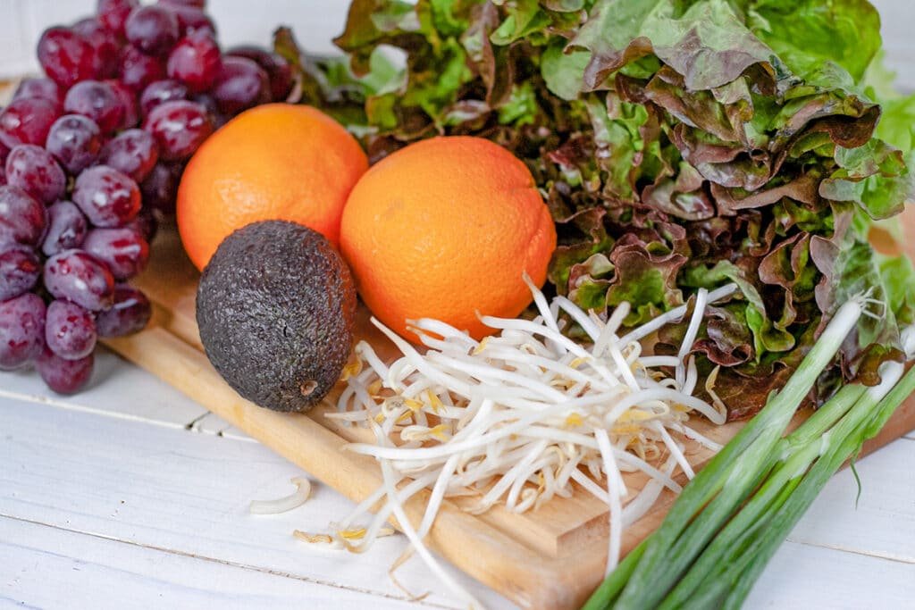 Salad ingredients laid out on a cutting board