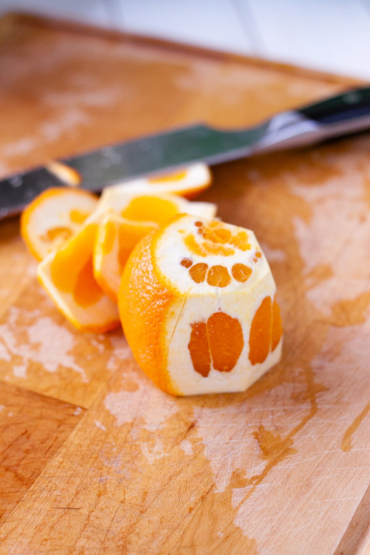 Cutting the rind from oranges