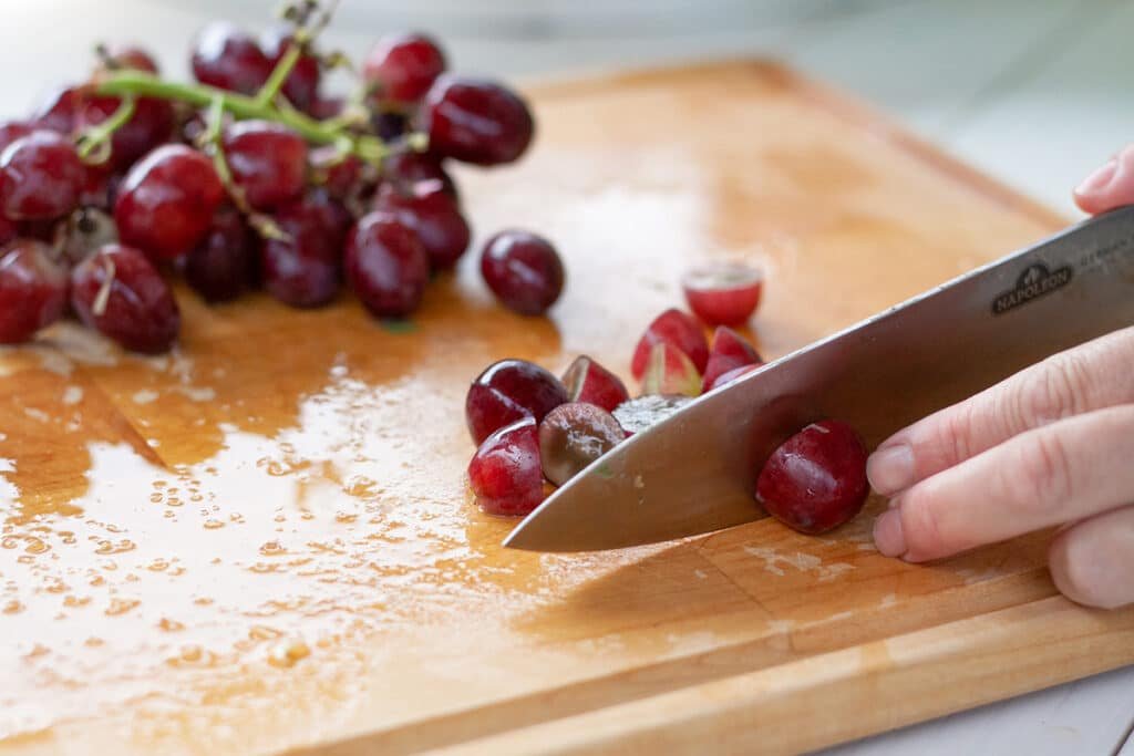 Cutting grapes on a cutting board