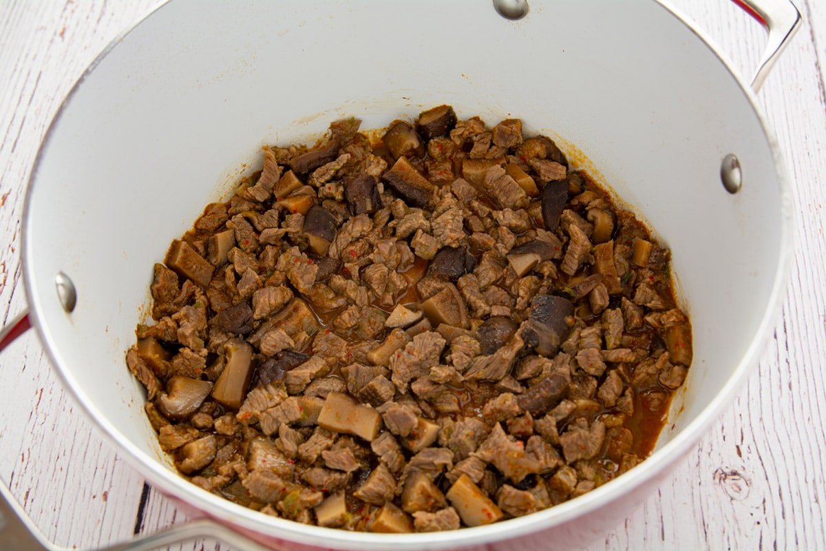 Diced beef in a pot after boiling.