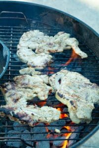 Pork steaks cooking on a grill
