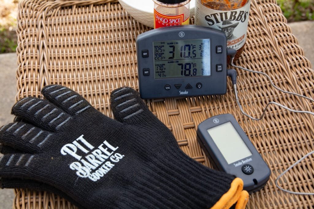 a digital thermometer monitoring the tempature inside of the cooker and internal tempature of the meat.