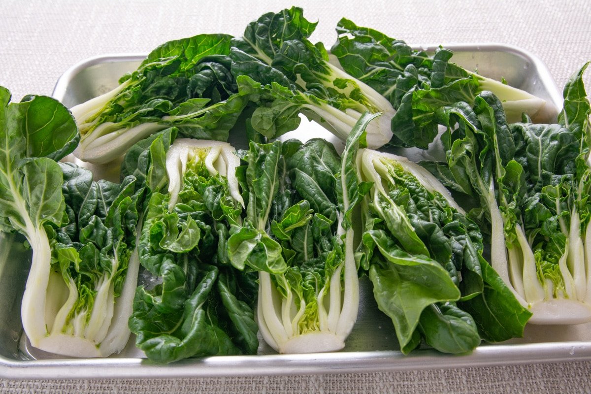 Cut and washed bok choy on a tray.