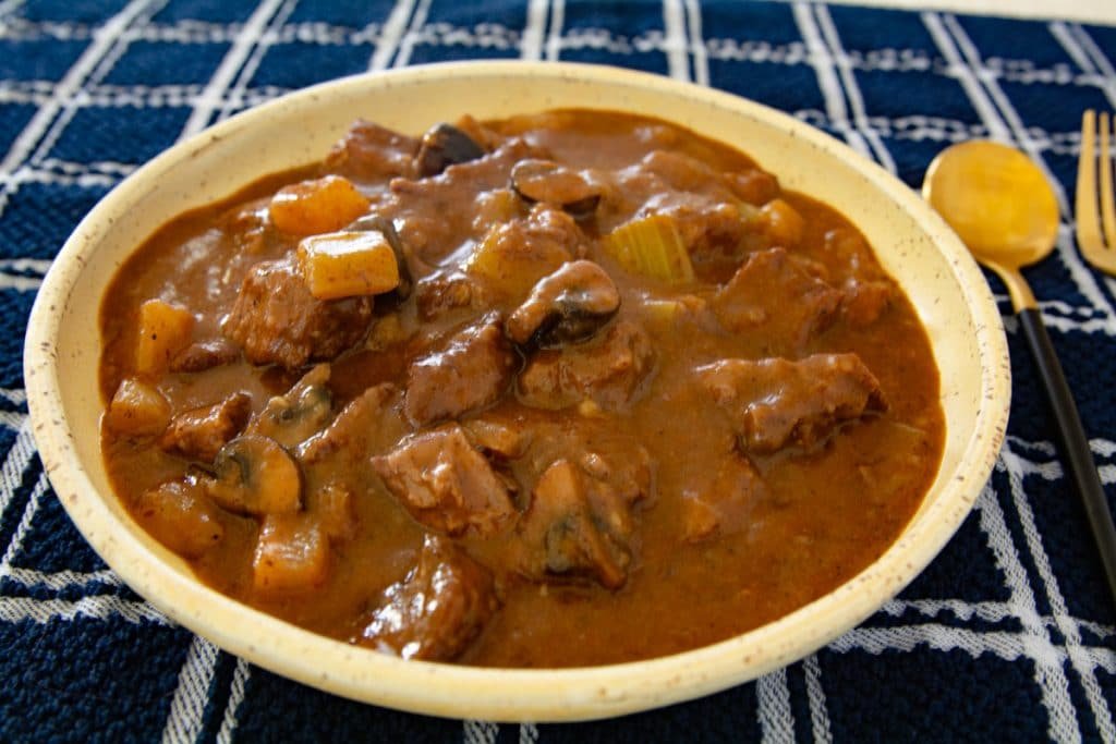 Bowl of beef stew on a table.