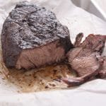 Cooked and sliced roast on paper.