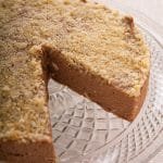 Cheesecake on a serving dish with a slice removed