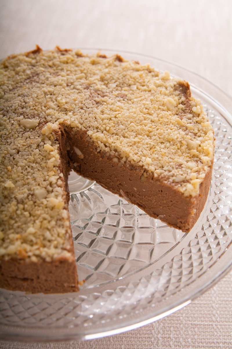 Cheesecake on a serving dish with a slice removed