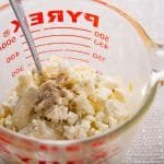 Blue cheese dressing ingredients in a measuring cup.