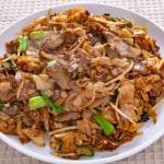 Plate of beef chow fun on a table