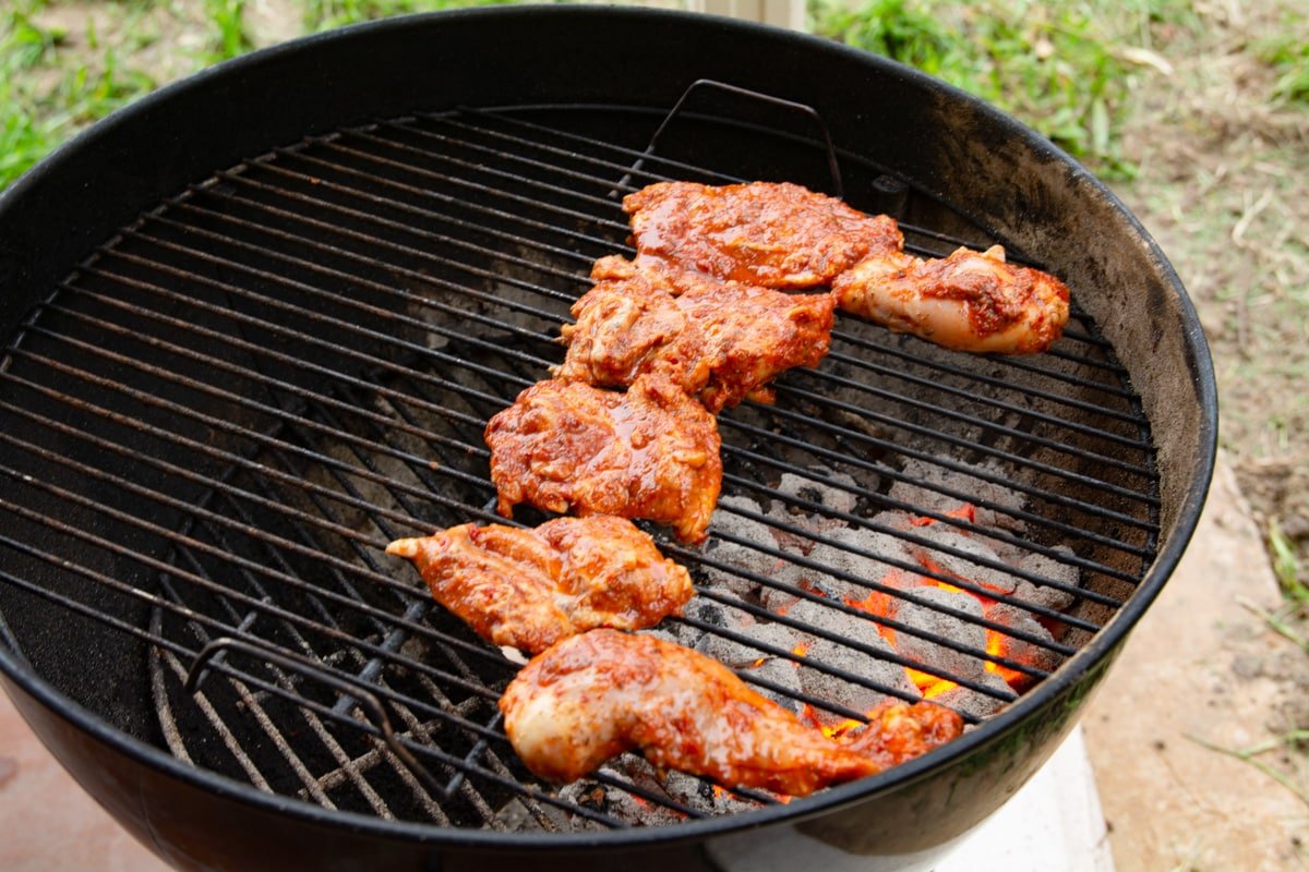 Chicken cooking on a grill using indirect heat