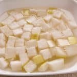 Diced up Korean radish in pickling liquid.