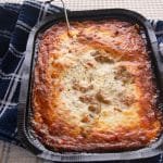 Tray of cooked lasagna on a table.