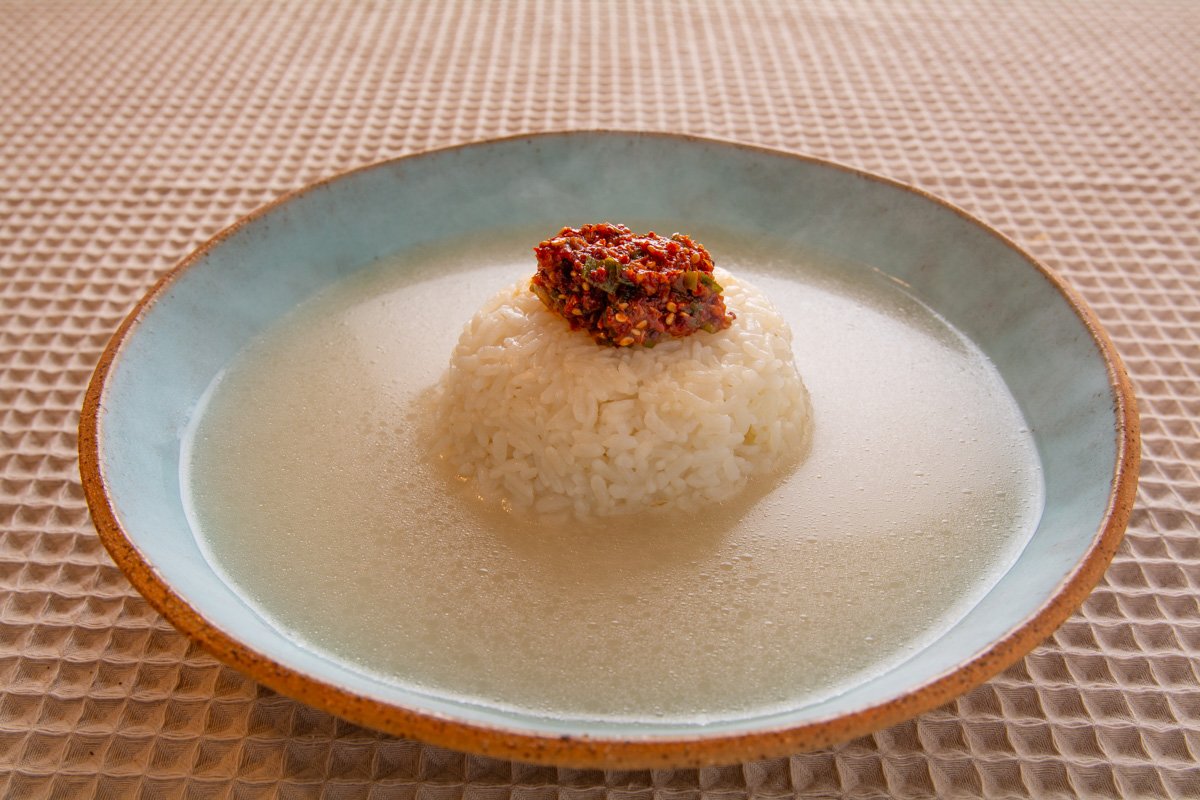 Bowl of finished soup with rice and seasoning mix