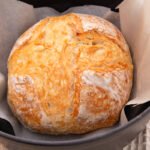 Fished bread in a pot with parchment paper.